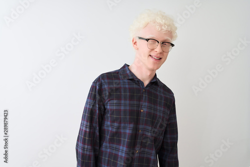 Young albino blond man wearing casual shirt and glasses over isolated white background winking looking at the camera with sexy expression, cheerful and happy face.