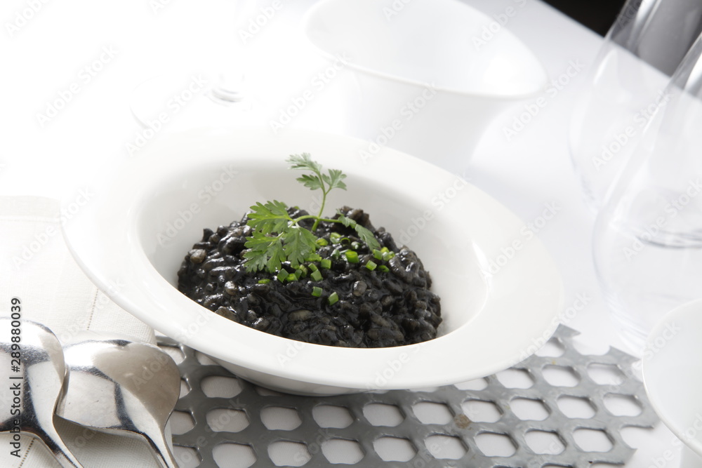 Arroz negro con calamar sobre bol. Black rice with squid on a bowl. Arroz negro con calamar sobre bol. Black rice with squid on a bowl.