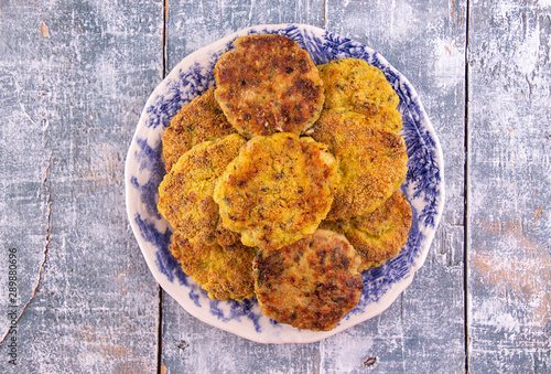 Juicy homemade fried meat and vegetable cutlets with herbs. Turkey, chicken, carrot,  onion, garlic, cubbage, eryngii mushroom, arugula, spinach. Top view photo