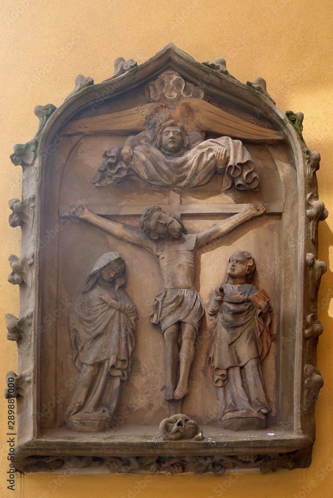 Crucifixion, relief on the house facade in Rothenburg ob der Tauber, Germany