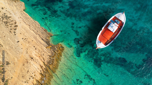 Aerial drone top down photo of traditional fishing wooden boat near main port of Koufonisi island, Small Cyclades, Greece