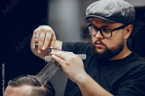 Hairdresser with a client. Man with a beard. Guy in a barbershop