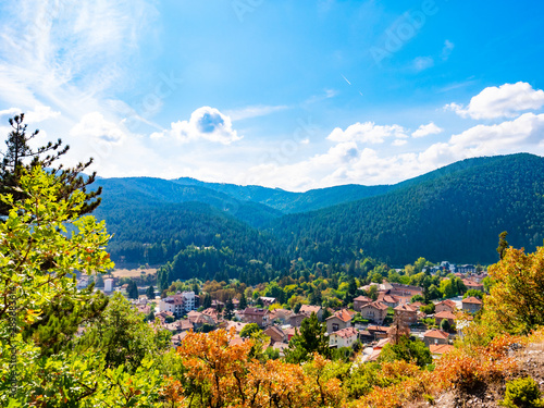 Scenic view of a mountain valley in autumn. Colourful countryside landscape with mountain forests and traditional houses. Balkan SPA capital Velingrad in Rhodope mountains photo