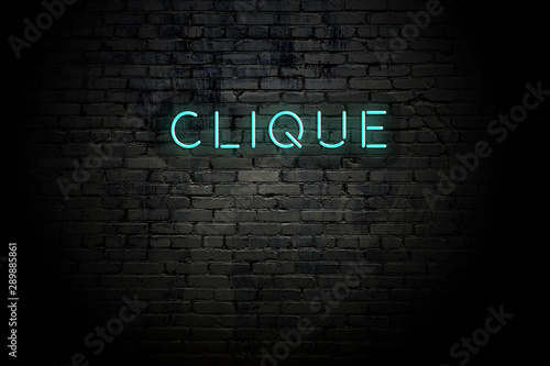 Highlighted brick wall with neon inscription clique