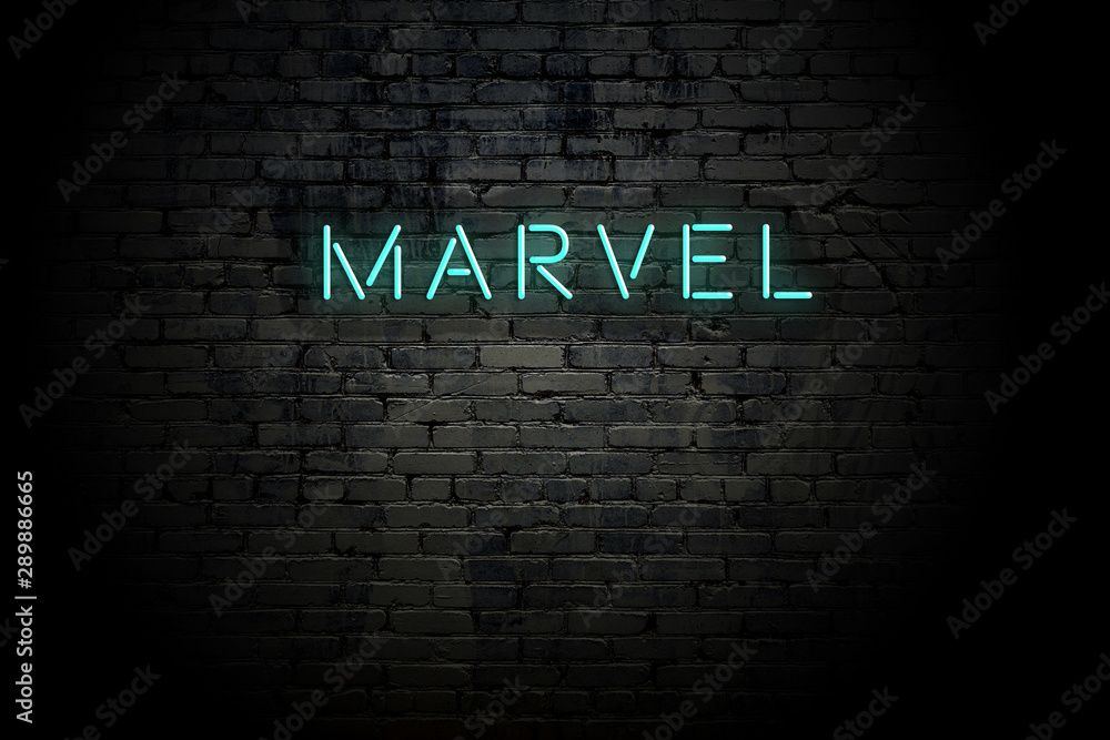 Naklejka premium Highlighted brick wall with neon inscription marvel