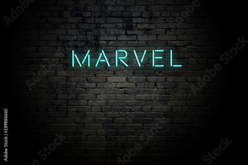 Highlighted brick wall with neon inscription marvel photo