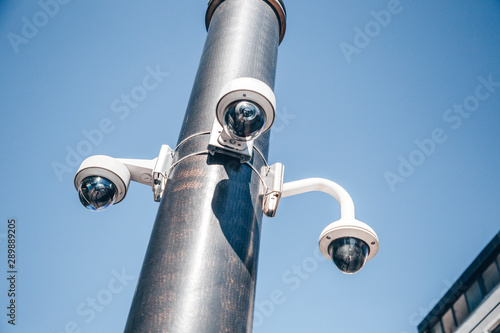 Modern surveillance cameras on the street. Cctv equipment. Blue sky on the background. Protection and control concept.