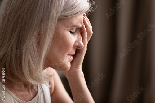 Close up unhappy hopeless mature woman thinking about problem