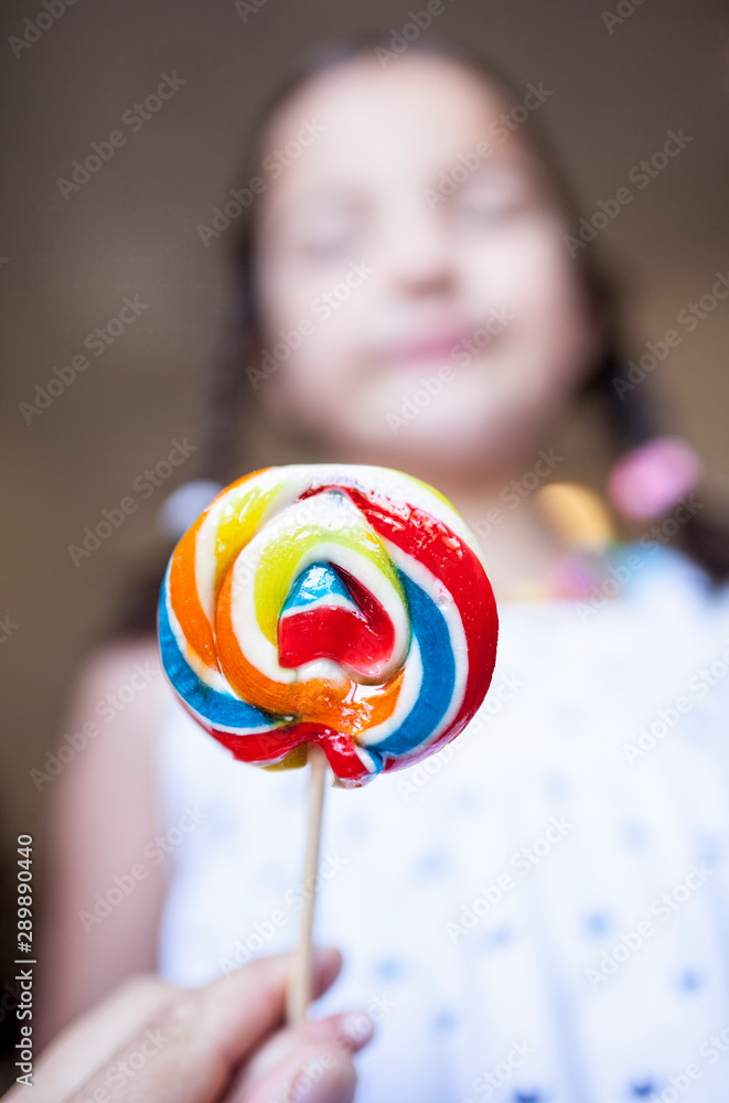 Child girl with colorful big lollipop Child girl with colorful big lollipop
