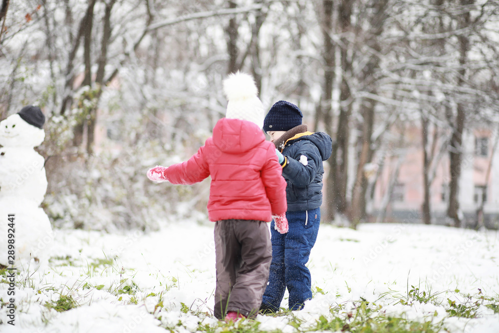 Children in winter park play Children in winter park play