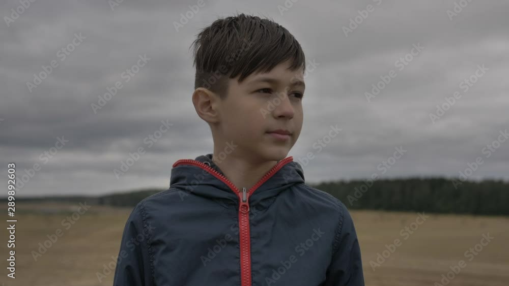 attentive boy looks around in autumn outdoors attentive boy looks around in autumn outdoors