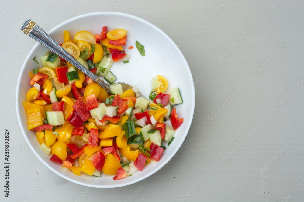 Fresh healthy salad with cherry tomatoes, cucumber, onion and bell pepper. Healthy food.