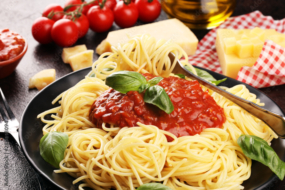 Plate of delicious spaghetti Bolognaise or Bolognese with savory minced beef and tomato sauce garnished with parmesan Plate of delicious spaghetti Bolognaise or Bolognese with savory minced beef and tomato sauce garnished with parmesan