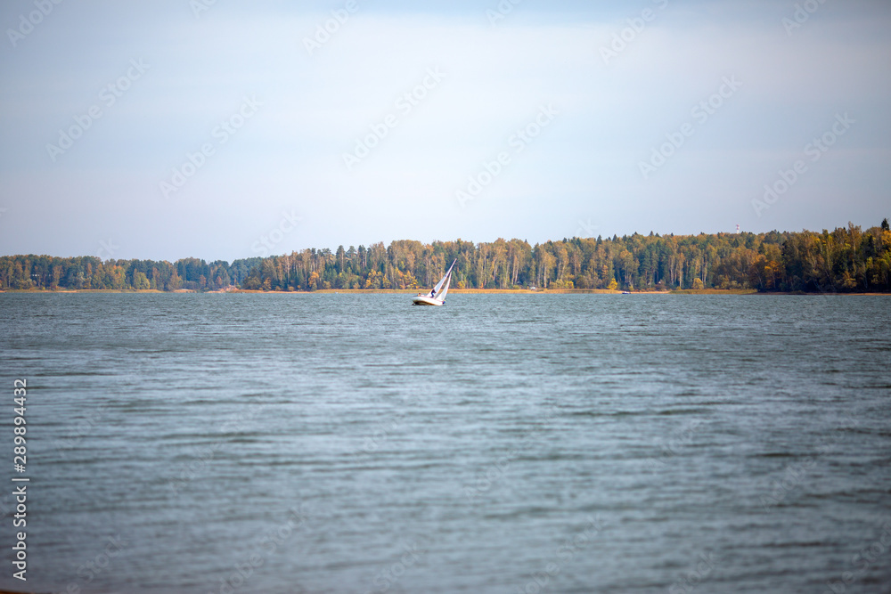 Photo of autumn forest, lake, yacht