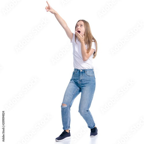 Woman in jeans casual clothing standing smiling showing pointing on white background isolation