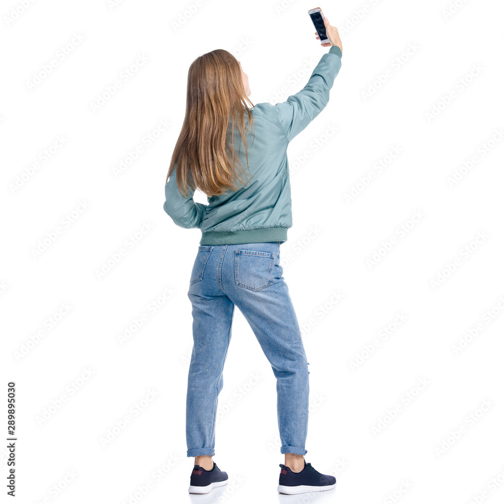 Woman in jeans coat jacket casual clothing standing smiling happiness making selfie on white background isolation, back view Woman in jeans coat jacket casual clothing standing smiling happiness making selfie on white background isolation, back view