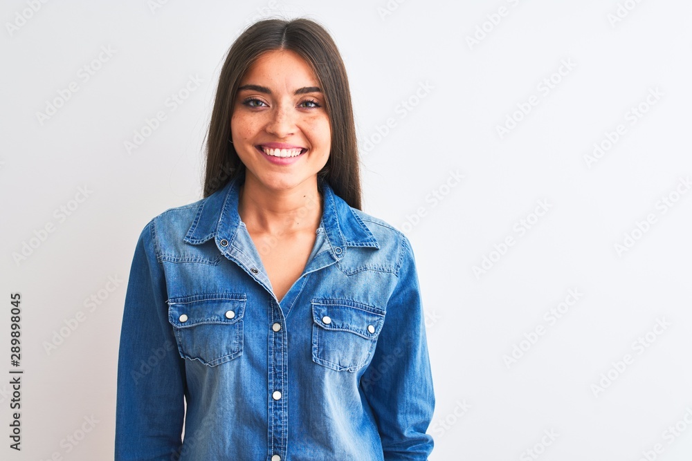 Young beautiful woman wearing casual denim shirt standing over isolated white background with a happy and cool smile on face. Lucky person. Young beautiful woman wearing casual denim shirt standing over isolated white background with a happy and cool smile on face. Lucky person.