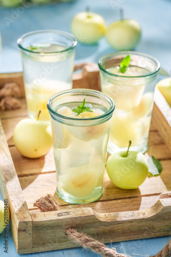 Closeup of tasty apple juice with apples and mint