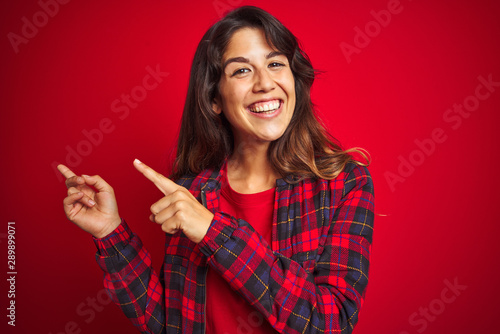 Young beautiful woman wearing casual jacket standing over red isolated background skeptic and nervous, disapproving expression on face with crossed arms. Negative person.