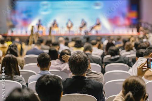 Rear view of Audience listening Speakers on the stage in the conference hall or seminar meeting, business and education about investment concept photo