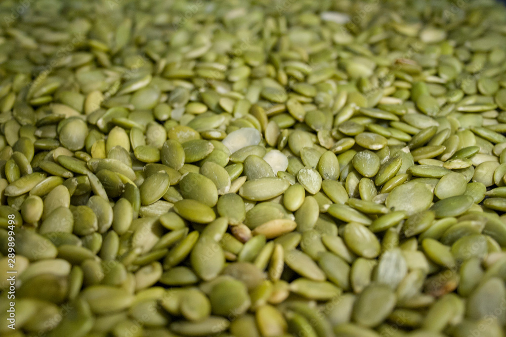 Macro background texture of green pumpkin seeds Macro background texture of green pumpkin seeds