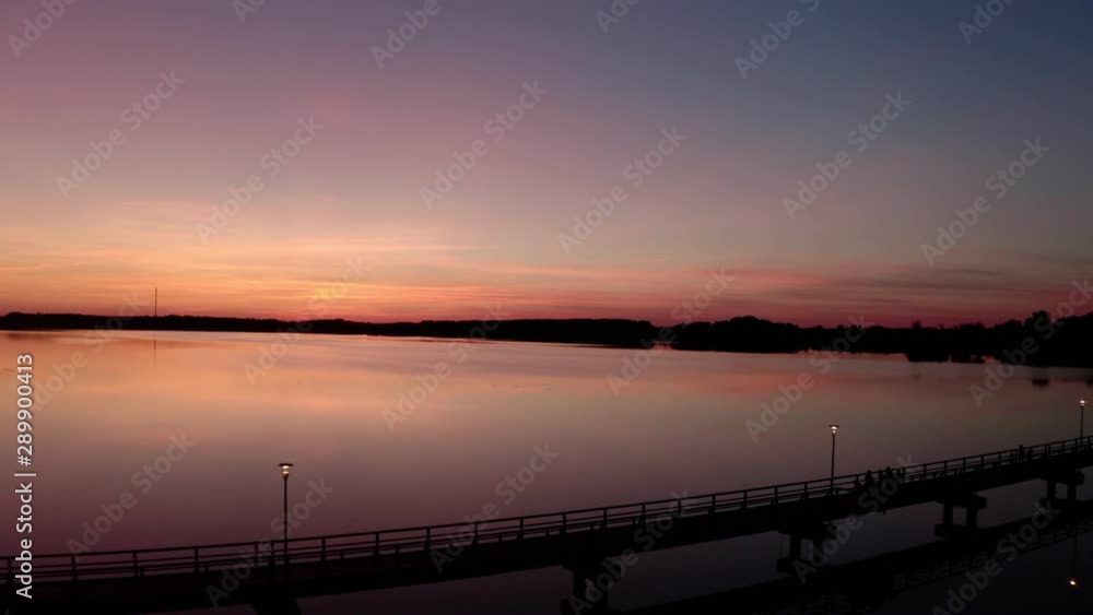 Flight by drone over the bridge of Lake Sirvėna. The wooden pedestrian bridge, the longest in Lithuania, over the artificial lake Sirvėna near Birzai. The bridge is located in Regional Park Flight by drone over the bridge of Lake Sirvėna. The wooden pedestrian bridge, the longest in Lithuania, over the artificial lake Sirvėna near Birzai. The bridge is located in Regional Park