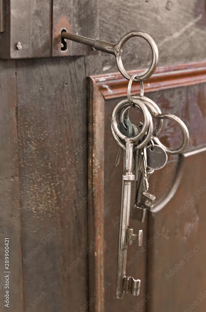 Medieval antique keys in a old door lock Medieval antique keys in a old door lock