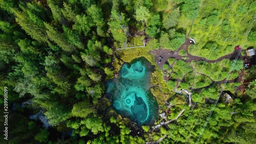 Beautiful Geyser lake with thermal springs that periodically throw blue clay and silt from the ground. Aerial drone view. Aktash, Altai mountains, Russia