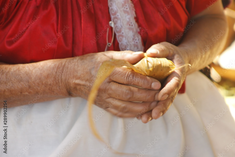 hands native women make mexican native food tamales