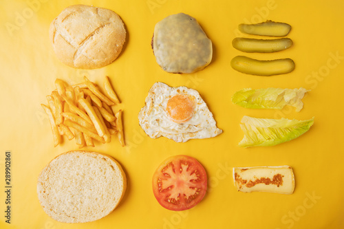 Ingredients for making hamburger on yellow background