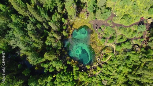 Beautiful Geyser lake with thermal springs that periodically throw blue clay and silt from the ground. Aerial drone view. Aktash, Altai mountains, Russia
