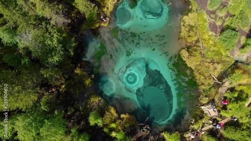 Beautiful Geyser lake with thermal springs that periodically throw blue clay and silt from the ground. Aerial drone view. Aktash, Altai mountains, Russia