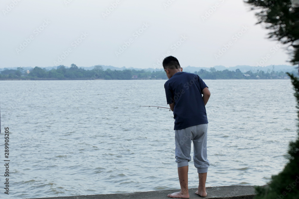 Little Boy Fishing In the River