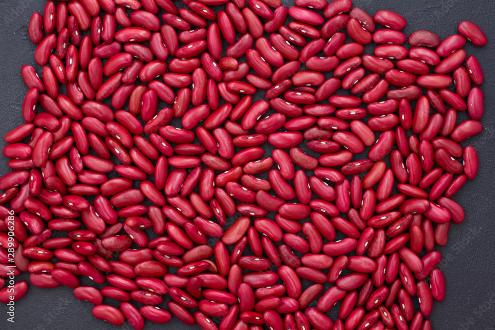 Red beans on a black background, top view. Red beans on a black background, top view.