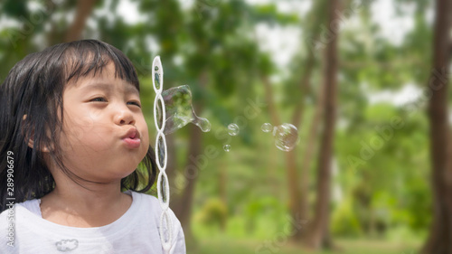 Little Girl Blows Bubbles