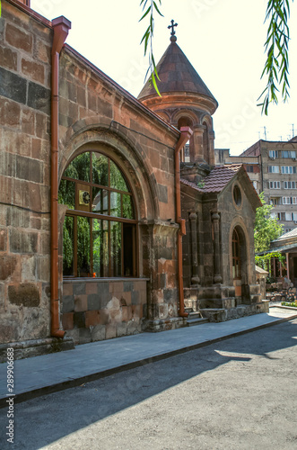 Part of the side of the medieval temple "Zoravor" with the Church of the Holy Virgin and the bell tower with the tomb of the Holy Apostle Ananias in the city of Yerevan
