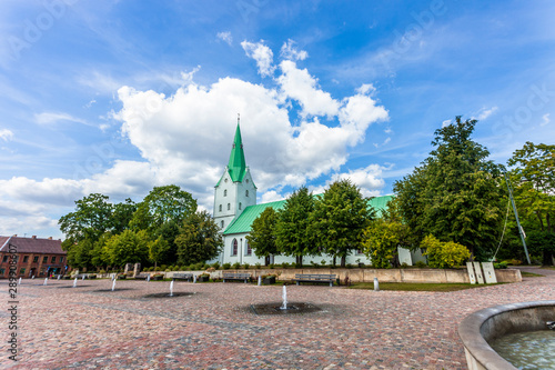 The Dobele Evangelic Lutheran Church built in 1495, Dobele, Latvia in sunny summer day. View from the Market square