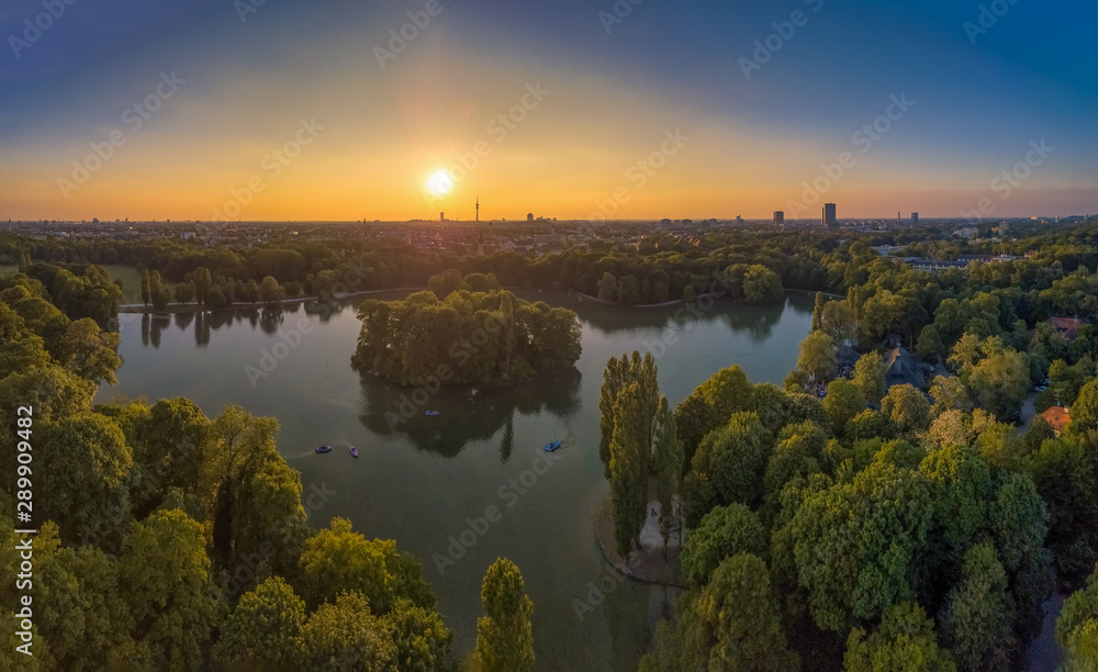 An idyllic park in the Englischer Garten of Munich with a beautiful lake as an aerial from a drone.