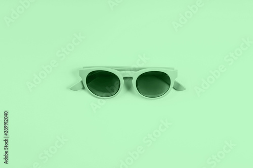 Mint green sun glasses. Monochrome Neo mint green color of 2020 fashion flat lay