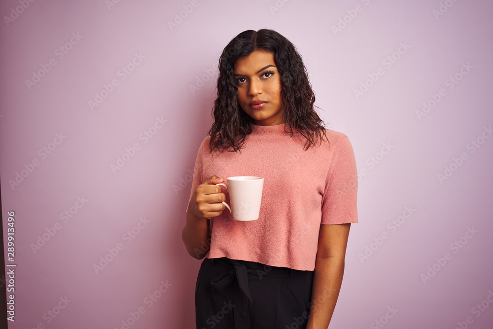 Transsexual transgender woman drinking cup of coffee over isolated pink background with a confident expression on smart face thinking serious Transsexual transgender woman drinking cup of coffee over isolated pink background with a confident expression on smart face thinking serious