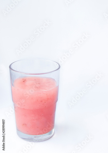 Drinking yogurt in a glass on a white background, copy space. Delicious pink fruit yogurt. Natural detoxification. Healthy eating concept. Fresh homemade yogurt for Breakfast. Fruit yogurt smoothie.