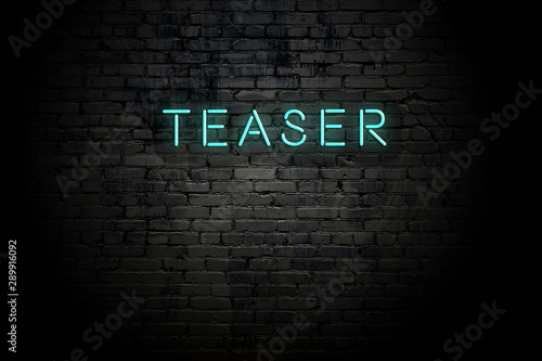 Highlighted brick wall with neon inscription teaser