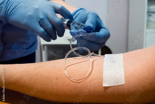 The introduction of the drug into the patient’s hand, Intravenous injection