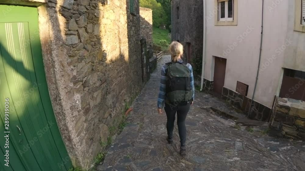 Woman Walking Through A Medieval Village Woman Walking Through A Medieval Village