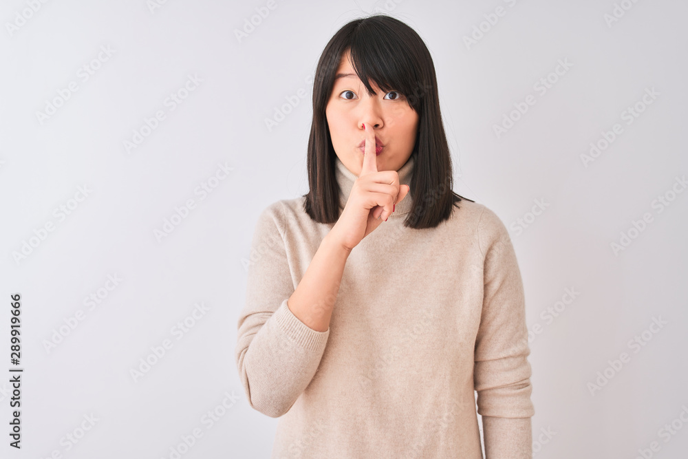 Young beautiful chinese woman wearing turtleneck sweater over isolated white background asking to be quiet with finger on lips. Silence and secret concept. Young beautiful chinese woman wearing turtleneck sweater over isolated white background asking to be quiet with finger on lips. Silence and secret concept.