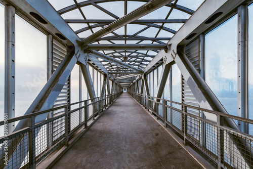 Metal and glass corridor above the highway.