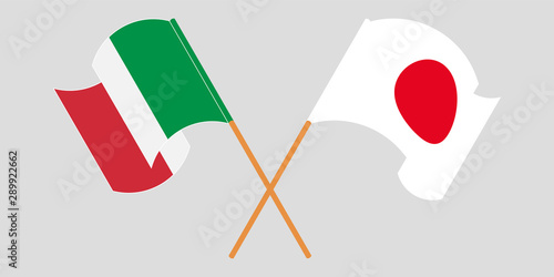 Crossed and waving flags of Italy and Japan
