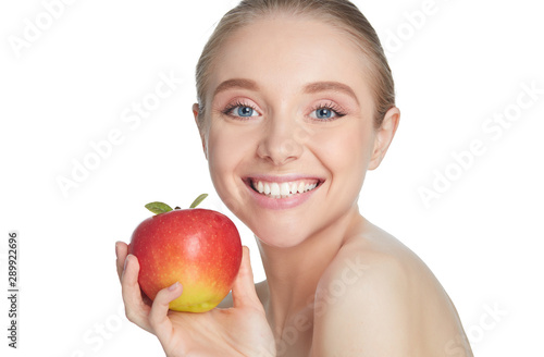 Cute young lady holding red apple while isolated on white background