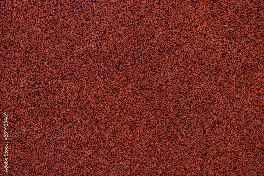 Fototapeta premium Red rubber coating for the Playground. The wheels are recycled and turned into a useful coating for the Playground. Rubber background painted in crimson color