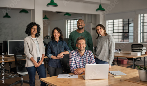 Diverse team of smiling designers working together in an office